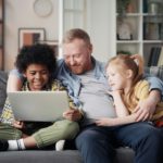 Father with children using laptop at home