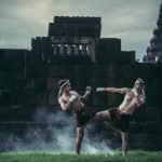 Two boxers fight with the martial arts of Muay Thai.